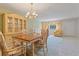 Elegant dining room area showcasing a large table, chairs, and decorative cabinet at 8830 Sw 98Th Pl # M, Ocala, FL 34481