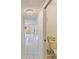 Bright hallway with tiled floors, leading to a cozy living area and a chandelier at 8830 Sw 98Th Pl # M, Ocala, FL 34481