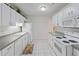 Bright kitchen featuring white appliances, ample counter space, and tiled flooring at 8830 Sw 98Th Pl # M, Ocala, FL 34481