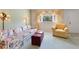 Comfortable living room with floral sofa, stylish armchair, and bright window at 8830 Sw 98Th Pl # M, Ocala, FL 34481