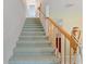 Carpeted staircase with wooden railing leading to the upper level of the home at 8830 Sw 98Th Pl # M, Ocala, FL 34481