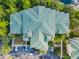 Overhead view of a well-maintained condo building with ample parking and landscaping, offering convenient and accessible living at 9061 Treasure Trove Ln # 403, Kissimmee, FL 34747