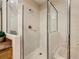Bathroom featuring a walk-in shower with glass doors, a vanity, and a sink at 9061 Treasure Trove Ln # 403, Kissimmee, FL 34747