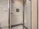 Tiled shower with glass doors and patterned tile accents, featuring a built-in seat at 9061 Treasure Trove Ln # 403, Kissimmee, FL 34747
