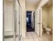 Modern bathroom featuring a tiled shower with glass doors, leading to bedroom at 9061 Treasure Trove Ln # 403, Kissimmee, FL 34747
