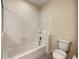 Clean, well-lit bathroom featuring a toilet and combination tub and shower at 9061 Treasure Trove Ln # 403, Kissimmee, FL 34747