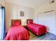 Well-lit bedroom featuring two twin beds, wood floors, and a closet at 9061 Treasure Trove Ln # 403, Kissimmee, FL 34747