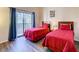Bedroom with twin beds and sliding glass doors that lead to an outdoor balcony at 9061 Treasure Trove Ln # 403, Kissimmee, FL 34747