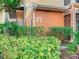Exterior of building number five with lush landscaping and stairs leading to multiple units above at 9061 Treasure Trove Ln # 403, Kissimmee, FL 34747