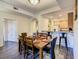 Inviting dining room with seating for six, seamlessly connecting to an open-concept kitchen and bright entryway at 9061 Treasure Trove Ln # 403, Kissimmee, FL 34747