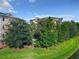 Lush landscaping surrounds the building; enjoy the view from your screened-in lanai at 9061 Treasure Trove Ln # 403, Kissimmee, FL 34747