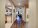 Interior hallway showcasing a kitchen, living area, and bathroom, all connected by arched doorways at 9061 Treasure Trove Ln # 403, Kissimmee, FL 34747
