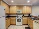 Kitchen showcasing appliances, countertop space, and light wood cabinets at 9061 Treasure Trove Ln # 403, Kissimmee, FL 34747