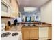 Modern kitchen sink with wood cabinets and countertops; open to the living room at 9061 Treasure Trove Ln # 403, Kissimmee, FL 34747