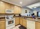 Well-equipped kitchen featuring wood cabinets, modern appliances, and ample counter space for meal preparation at 9061 Treasure Trove Ln # 403, Kissimmee, FL 34747