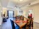 Bright, airy living area flowing into the dining space, enhanced by neutral tones and lots of natural light at 9061 Treasure Trove Ln # 403, Kissimmee, FL 34747