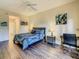 Comfortable main bedroom featuring hardwood floors, a ceiling fan, and versatile layout for furnishings at 9061 Treasure Trove Ln # 403, Kissimmee, FL 34747