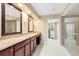 Spacious bathroom with double vanity, granite counters, large walk-in shower, and access to a walk-in closet at 918 Lotus Vista Dr # 102, Altamonte Springs, FL 32714