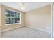Bright bedroom with a ceiling fan, a carpet and a large window at 918 Lotus Vista Dr # 102, Altamonte Springs, FL 32714