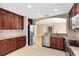 Open kitchen featuring granite countertops, stainless steel appliances, and dark wood cabinetry at 918 Lotus Vista Dr # 102, Altamonte Springs, FL 32714