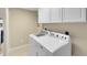 Laundry area with modern, white front-loading washer and dryer at 918 Lotus Vista Dr # 102, Altamonte Springs, FL 32714