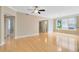 Bright living room with hardwood floors, crown molding, ceiling fan, and large windows with neighborhood views at 918 Lotus Vista Dr # 102, Altamonte Springs, FL 32714