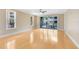 Expansive living room with sliding glass doors leading to the balcony, complemented by hardwood floors and natural light at 918 Lotus Vista Dr # 102, Altamonte Springs, FL 32714