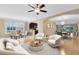 Bright living room featuring hardwood floors, ceiling fan, and an open floor plan with views of the kitchen and dining area at 918 Lotus Vista Dr # 102, Altamonte Springs, FL 32714