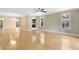 Spacious living room with beautiful hardwood floors, large windows, and an open view to the kitchen offers a modern design at 918 Lotus Vista Dr # 102, Altamonte Springs, FL 32714