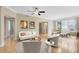 Bright living room featuring a comfortable seating area, hardwood floors and a view of the dining area at 918 Lotus Vista Dr # 102, Altamonte Springs, FL 32714