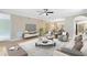 Spacious living room featuring an open floor plan, comfortable seating, hardwood floors, and natural lighting at 918 Lotus Vista Dr # 102, Altamonte Springs, FL 32714