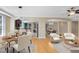 Open concept living space with hardwood flooring, dining area, kitchen with bar seating, and a comfortable living area at 918 Lotus Vista Dr # 102, Altamonte Springs, FL 32714