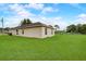 Home featuring a large backyard with a well-maintained lawn and beautiful exterior paint at 927 Cambridge Ct, Kissimmee, FL 34758
