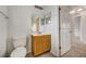 Clean bathroom featuring a vanity with ample storage, a toilet, and a well-lit mirror at 927 Cambridge Ct, Kissimmee, FL 34758