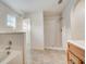 Spacious bathroom with bathtub, shower, and wooden vanity at 927 Cambridge Ct, Kissimmee, FL 34758