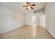Vaulted ceiling primary bedroom with tile flooring and open doorway at 927 Cambridge Ct, Kissimmee, FL 34758