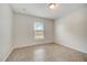 Bright bedroom with a window and tile floors providing a clean and simple space at 927 Cambridge Ct, Kissimmee, FL 34758