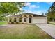 Charming single-story home with a well-manicured lawn and attached two-car garage at 927 Cambridge Ct, Kissimmee, FL 34758
