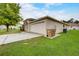 Side view of attached two-car garage with convenient trash can storage at 927 Cambridge Ct, Kissimmee, FL 34758