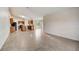 Open-concept living area leading to kitchen with dark cabinets and tile flooring at 927 Cambridge Ct, Kissimmee, FL 34758
