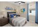 Comfortable bedroom featuring blue accents, stylish shelves, and a window providing natural light at 9560 Archway Aly, Orlando, FL 32832