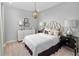 Stylish bedroom features a gold chandelier, neutral colors, and elegant furnishings at 9560 Archway Aly, Orlando, FL 32832