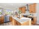 Modern kitchen boasts stainless steel appliances, center island, and open layout into the living area at 9560 Archway Aly, Orlando, FL 32832