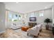 Comfortable living room featuring hardwood floors, neutral décor, and ample natural light at 9560 Archway Aly, Orlando, FL 32832
