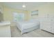 Airy bedroom with hardwood floors, a white bed, and a dresser with white trim at 9635 Fenrose Ter, Orlando, FL 32827