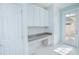 Functional desk area with granite countertop and storage, adjacent to the entryway at 9635 Fenrose Ter, Orlando, FL 32827