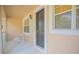 Front porch featuring a gray entry door and outdoor seating at 9635 Fenrose Ter, Orlando, FL 32827