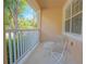 Covered front porch with cozy seating area and white railing at 9635 Fenrose Ter, Orlando, FL 32827