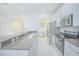 Spacious kitchen features stainless steel appliances and granite countertops with bar seating at 9635 Fenrose Ter, Orlando, FL 32827