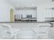 Modern kitchen with stainless appliances, gray countertops, and white cabinetry with bar seating at 9635 Fenrose Ter, Orlando, FL 32827